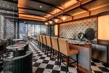 the lobby of a restaurant with a bar and chairs at The Grand Central, Illinois, 60607